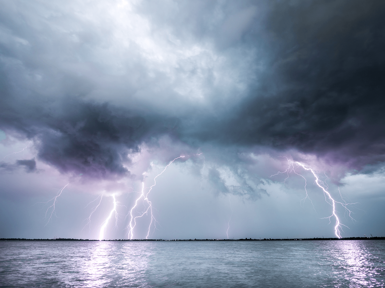 Clouded sky and lightening over water