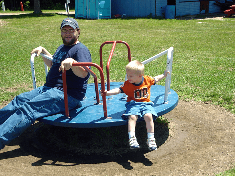 Brad and his nephew on a playground.